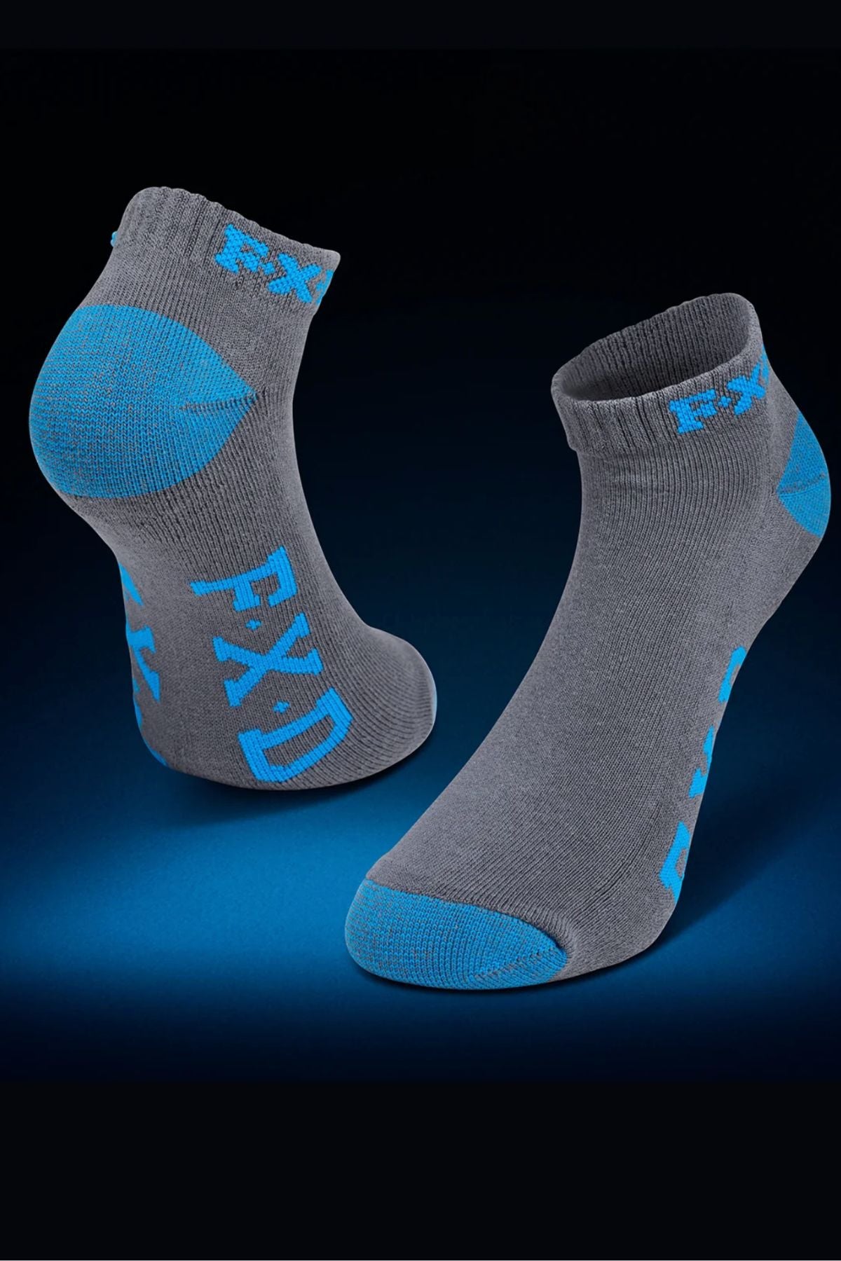 The FXD SK-3 Ankle Sock 5 Pack includes durable gray work socks with blue accents on the heel, toe, and sole, plus "FXD" in blue. They feature a padded foot bed for comfort and are displayed on a blue gradient background.