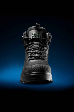 The FXD WB-6 Work Boot, in black, is showcased against a dark gradient background. It boasts a robust sole, reinforced toe, and an advanced synthetic upper accented with a lace-up design and additional supportive straps. For enhanced comfort, it includes a PORON® heel insert, with "FIXD" prominently displayed on the tongue.