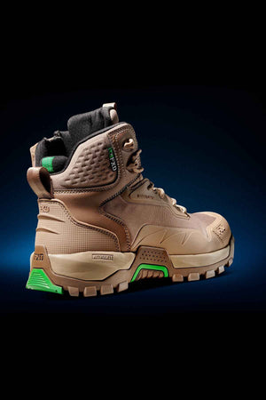 The FXD WB-6 Work Boot is a brown high-top work boot with a rugged design, featuring green accents and a black padded collar. It comes equipped with a thick, durable sole with tread pattern, reinforced toe and heel areas for added durability, and includes a PORON heel insert for enhanced comfort. The background showcases a gradient of dark blue to black.