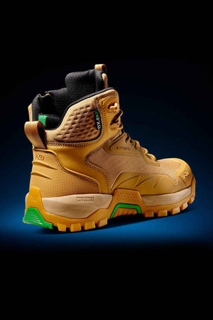 The FXD WB-6 Work Boot is a robust, tan hiking boot equipped with a padded ankle collar, black laces, and a green outsole. It features textured detailing and includes a Poron heel insert for added comfort. The boot also has a convenient loop at the back for easy wearing and showcases a label on the side adorned with green accents. Displayed against a dark gradient background, the FXD WB-6 Work Boot combines style and functionality seamlessly.