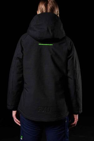 A person with blonde hair is seen from behind wearing the FXD WO-1W Womens Insulated Work Jacket, which is black with a small green stripe on the upper back, standing against a dark background.