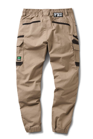 FXD WP-12C tan cargo pants in durable 2-way stretch ripstop with black zipper utility pockets, elastic cuffs, a black FXD waistband logo, and a green FXD patch on the left cargo pocket. Shown laid flat from the back.