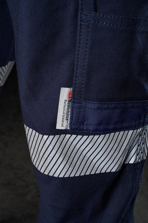 Close-up of a dark blue FXD WP-3T work pant with a small pocket. The pocket has a white label with red and black text that reads "3X.learn." and "Elektrostatic Bart AR." The pant features a reflective tape stripe pattern for visibility and 360-degree stretch for optimal comfort.