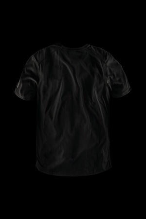 The FXD WT-3 Tech Tee, a black short-sleeve t-shirt renowned for its comfort, is showcased against a solid black background. The shirt features a plain design with subtle wrinkles and a slightly curved hem at the bottom.