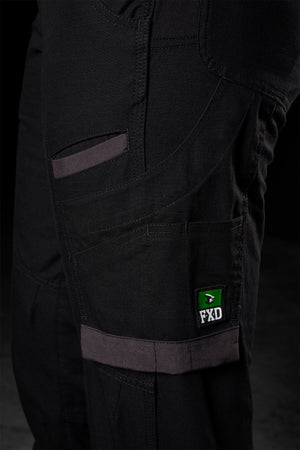 Close-up of a pair of FXD Womens WP-8W black pants showcasing multiple pockets, reinforced stitching, and a distinctive green label with the text "FXD." The gray-accented pockets and durable appearance indicate practicality. These lightweight stretch ripstop pants also feature abrasion panels, making them ideal for work or outdoor activities.