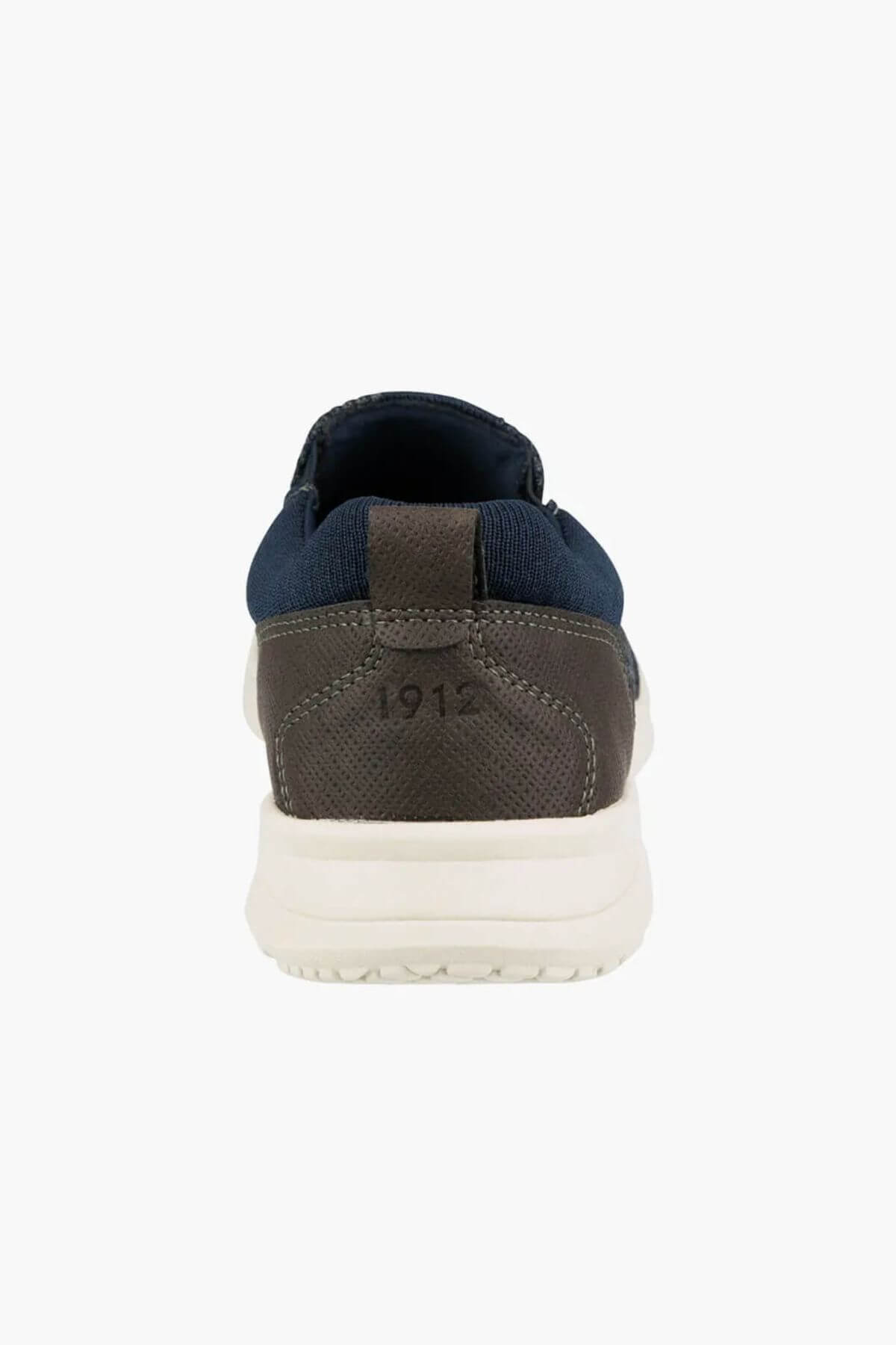 A rear view of the Florsheim Conway Knit Moc Toe Slip On, featuring a blue upper, brown heel embossed with "1912," and a white sole.
