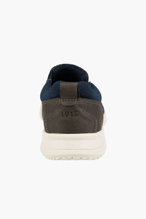 A rear view of the Florsheim Conway Knit Moc Toe Slip On, featuring a blue upper, brown heel embossed with "1912," and a white sole.