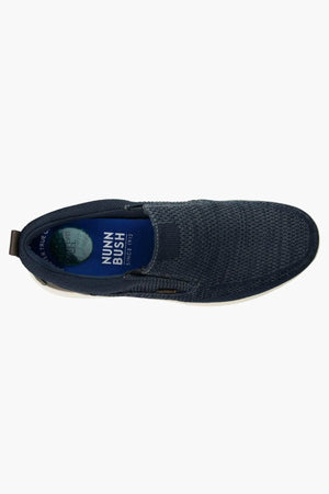 Top view of a single dark blue Florsheim Conway Knit Moc Toe Slip On shoe with a white sole, featuring the brand logo on the memory foam insole for added comfort.