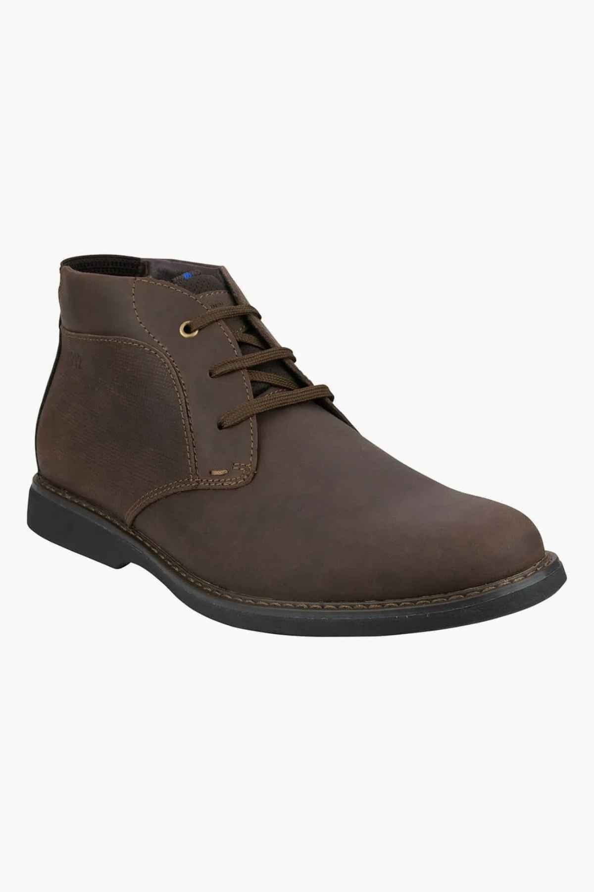 The Florsheim Otto Chukka Boot is a brown leather ankle boot with a leather upper, dark laces, black rubber sole, textured finish, and visible stitching. It features a cushioned footbed and offers a classic design ideal for casual or semi-formal wear.