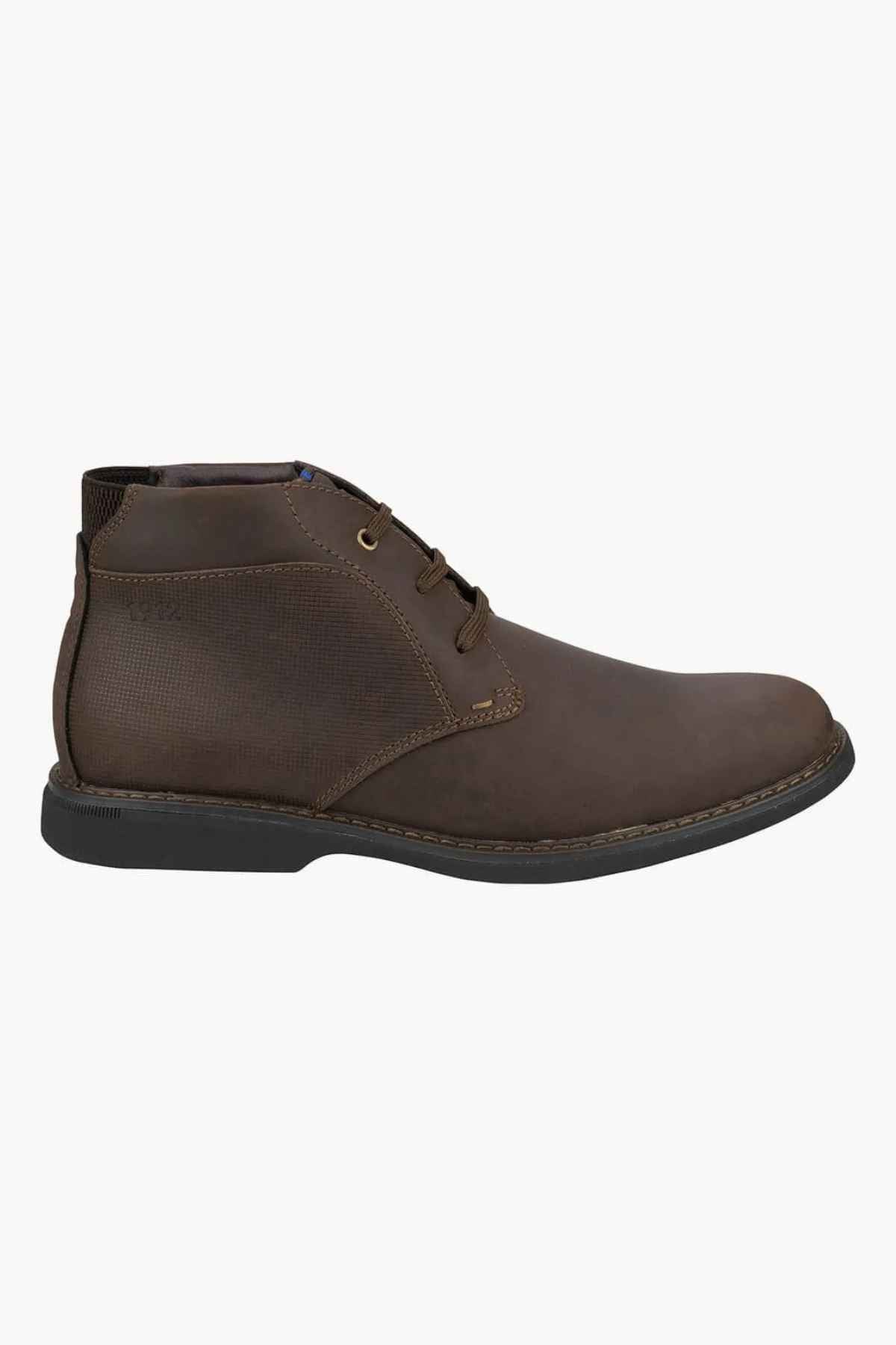 The Florsheim Otto Chukka Boot showcases a brown leather upper with a textured side panel and lace-up design set against a white background, offering all-day comfort with its cushioned footbed.