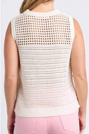 A person is seen from behind wearing a sleeveless, cream Foxwood Chilli Knit Top made of 100% cotton, featuring a patterned semi-transparent back, paired with light pink pants.