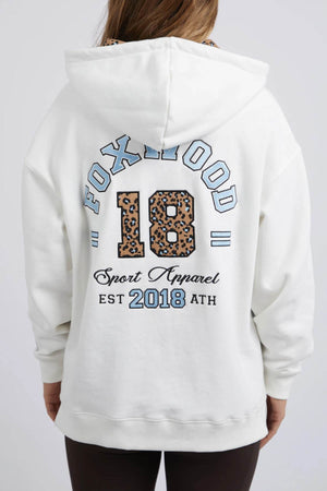 The Foxwood Established Hoody is a relaxed fit, white hoodie featuring "FOXWOOD 18" in blue and leopard print across the back, "Sport Apparel EST 2018 ATH" below, chest embroidery, and long sleeves.