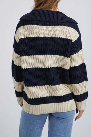 A person is shown from the back wearing the Foxwood Estella Stripe Knit, featuring chunky yarn-dyed stripes and a wide collar, paired with light blue jeans.