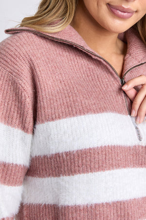A close-up of a person wearing the Foxwood Gracie Zip Crew in pink and white stripes. The person's hand lightly touches the zip neckline, with only their lower face and hair visible.