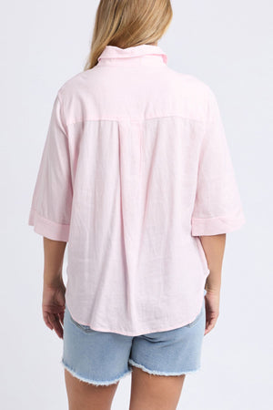 A woman wearing the Foxwood Leah Shirt, a relaxed fit pink linen top with 3/4 sleeves.
