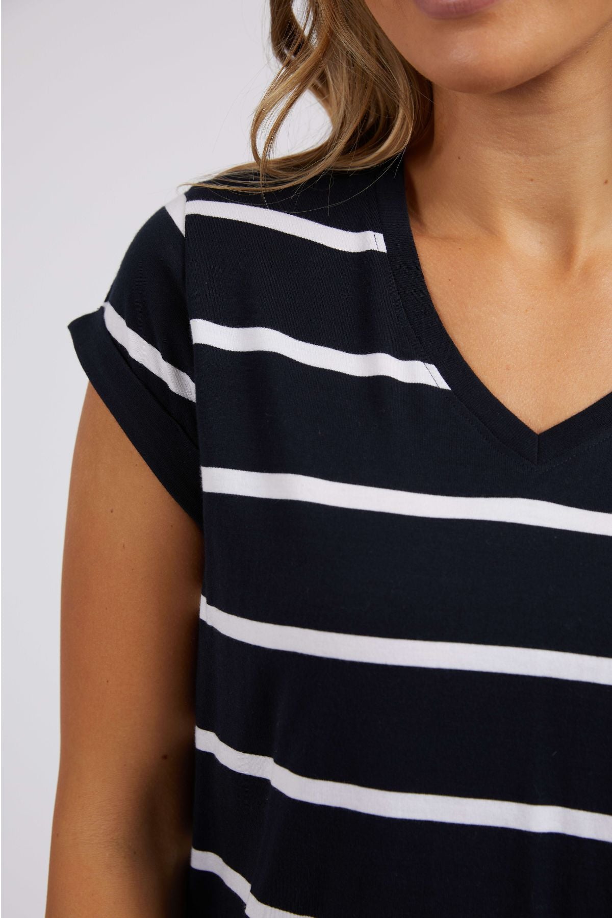 The Foxwood Manly Stripe Vee Tee, a Pima cotton jersey T-shirt with black and white yarn-dyed stripes and short sleeves, is shown from the shoulders down against a plain light gray background.