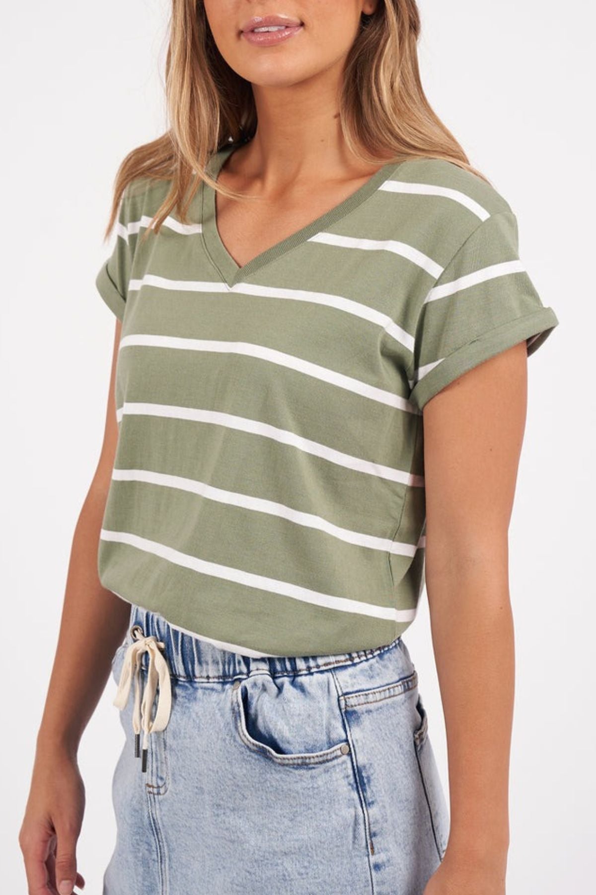 A person wearing the Foxwood Manly Stripe Vee Tee with rolled-up sleeves and light blue jeans stands casually against a plain white background.