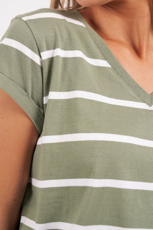 Close-up of a person wearing the Foxwood Manly Stripe Vee Tee, highlighting the upper torso and shoulder area. This tee is made from Pima cotton jersey and showcases short sleeves with evenly spaced horizontal white stripes on a muted green background.