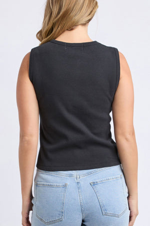 A person with light brown hair is shown from the back, wearing the Foxwood Raf Button Through Tank in black and light blue jeans with visible back pockets, set against a plain light background.