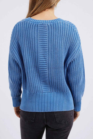 A person in the Foxwood Winnie Knit Crew, a relaxed-fit jumper with a ribbed design and long sleeves, is shown from the back wearing black jeans. The plain white background accentuates its cozy, chunky knit look.