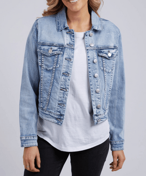 Wearing the Foxwood Georgia Denim Jacket against a plain background, the person exudes effortless style with this smart-casual staple, layered over a white shirt and paired with black pants.