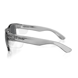 A pair of transparent, foldable SafeStyle Fusions goggles with dark polarised lenses, featuring "Style" printed on the side. They have durable polycarbonate frames and are shown from a side angle against a white background.