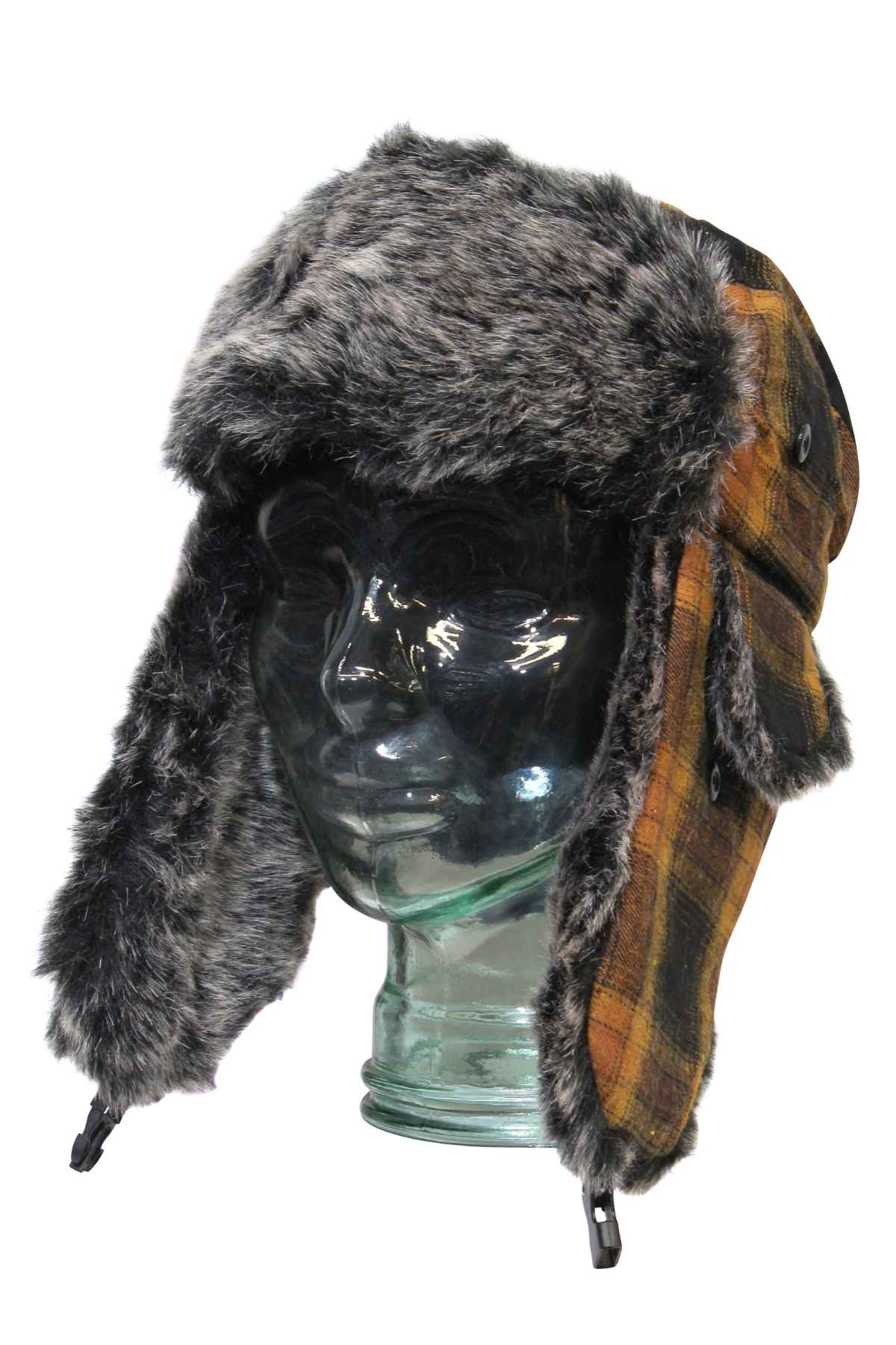 A glass mannequin head displays the GUM Arctic Trooper, a fur-lined flying cap with long ear flaps and a brown, yellow, and black plaid patternβperfect for cold winter days.