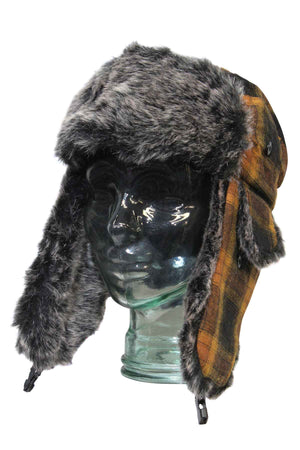A glass mannequin head displays the GUM Arctic Trooper, a fur-lined flying cap with long ear flaps and a brown, yellow, and black plaid patternβperfect for cold winter days.