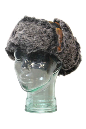 A glass mannequin head displays the GUM Arctic Trooper, a thick gray faux fur winter flying cap with side flaps, against a white backgroundβideal for versatile chilly-weather looks.