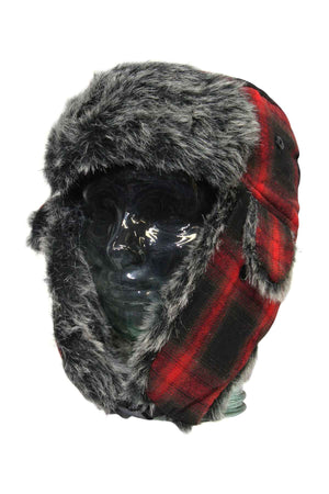 A glass head mannequin wears the GUM Arctic Trooper, a red and black plaid flying cap with gray fluffy lining on the ear flaps and brim, set against a plain white background.