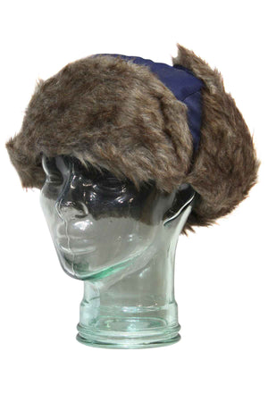 A glass mannequin head wears a GUM Eskimo Trooper hat in blue, featuring brown faux fur trim and fluffy lining.