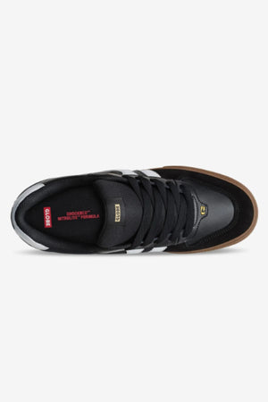 Top view of the Globe Encore-2: black sneaker with white side stripes, brown herringbone outsole, and black laces. Red insole features “SHOCKBED™ INSOLE FORMULA” and “GLOBE” in white. Durable skate shoe designed for comfort.