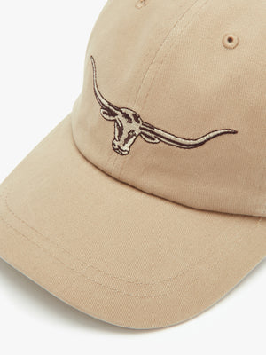 The RM Williams Longhorn Cap is a beige baseball cap made from cotton twill, featuring an embroidered longhorn steer head on the front, ventilation eyelets on the top, and an adjustable back strap.