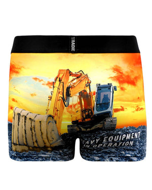 The Tradie Mens Work N Surf Trunk features moisture-wicking, quick-drying fabric and a bold yellow excavator at sunset, with "HEAVY EQUIPMENT IN OPERATION" partially visible on the design.