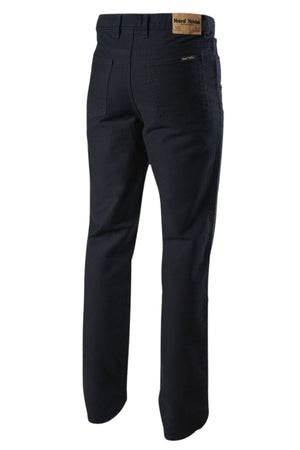 The Hard Yakka Moleskin Plain Front Heavy Duty Work Jean in dark blue is shown from the back, with two rear pockets, belt loops, and a branded brown leather patch above the right pocket—perfect for tough jobs.