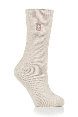 Introducing the Heat Holders Ladies Original Thermal Heat Sock in beige. This single wool sock features a ribbed texture and a small brown tag near the top, adorned with a flame logo. Warm and cozy, it boasts an impressive TOG rating of 2.3 for superior insulation. The sock is showcased standing upright at a slight angle against a plain white background, highlighting its design and texture effectively.