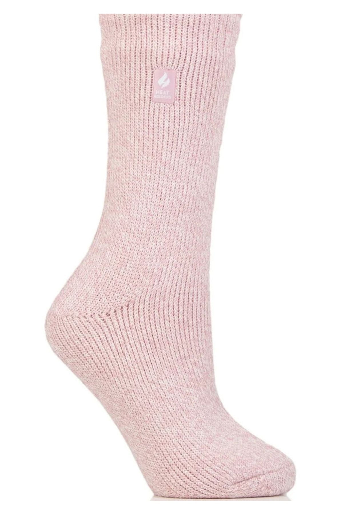 The Heat Holders Ladies Original Thermal Heat Sock is shown upright in light pink against a white background, featuring a small rectangular label near the top with a flame logo and text—ideal for those seeking warm, cozy crew socks.