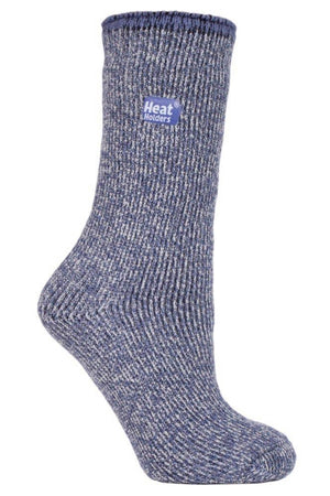 The Heat Holders Ladies Wool Sock is a single, thick blue sock with a ribbed texture, featuring a small "Heat Holders" logo near the top. Designed to provide warmth and comfort, these Merino Wool socks are perfect for outdoor activities. The fabric appears soft and cozy, making it ideal for cold weather.