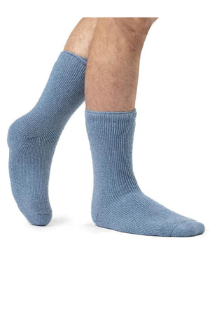 Two feet clad in Heat Holders Mens Wool Sock, featuring a blue ribbed wool design, confidently stand on a white background, ideal for outdoor activities.
