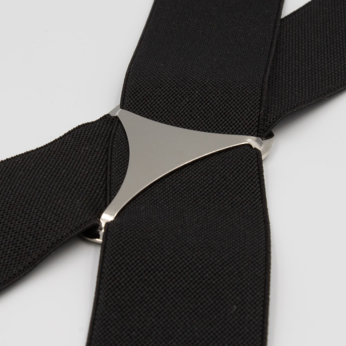 Close-up of Buckle Plain Braces featuring a silver triangle-shaped connector in the center and high-quality clasps, set against a white background. The black adjustable straps exhibit a textured appearance.