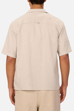 A person wearing the Industrie The Almeria Short Sleeve Shirt in light beige cotton with a camp collar and matching shorts is shown from the back against a plain white background.
