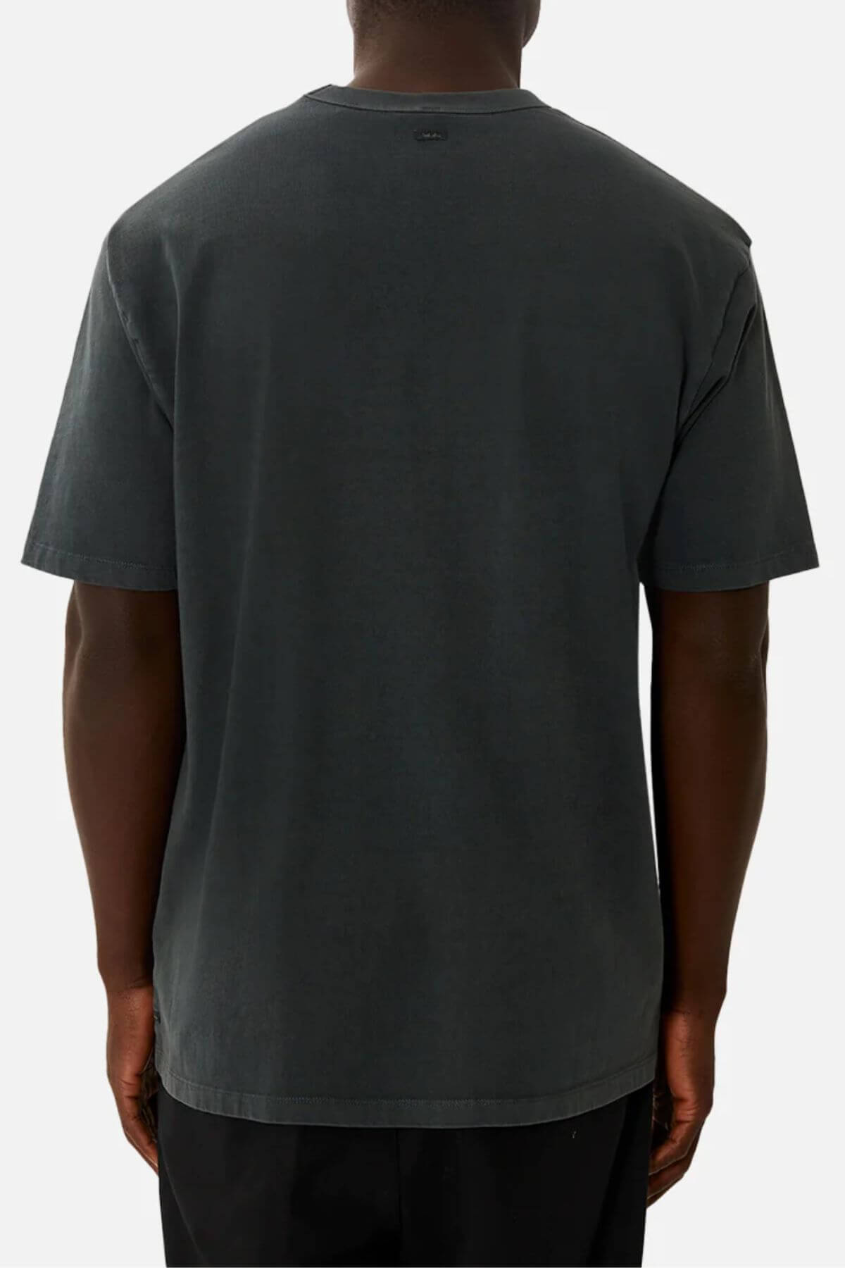 A person faces away from the camera, wearing an oversized Industrie The Del Sur Tee in plain dark color, crafted from 100% cotton. A simple background highlights the back of this short-sleeve shirt.