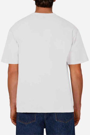A person facing away, wearing an oversized fit Industrie The Del Sur Tee in plain white and paired with blue jeans against a white background. This comfortable T-shirt is crafted from 100% cotton, ensuring both style and ease.