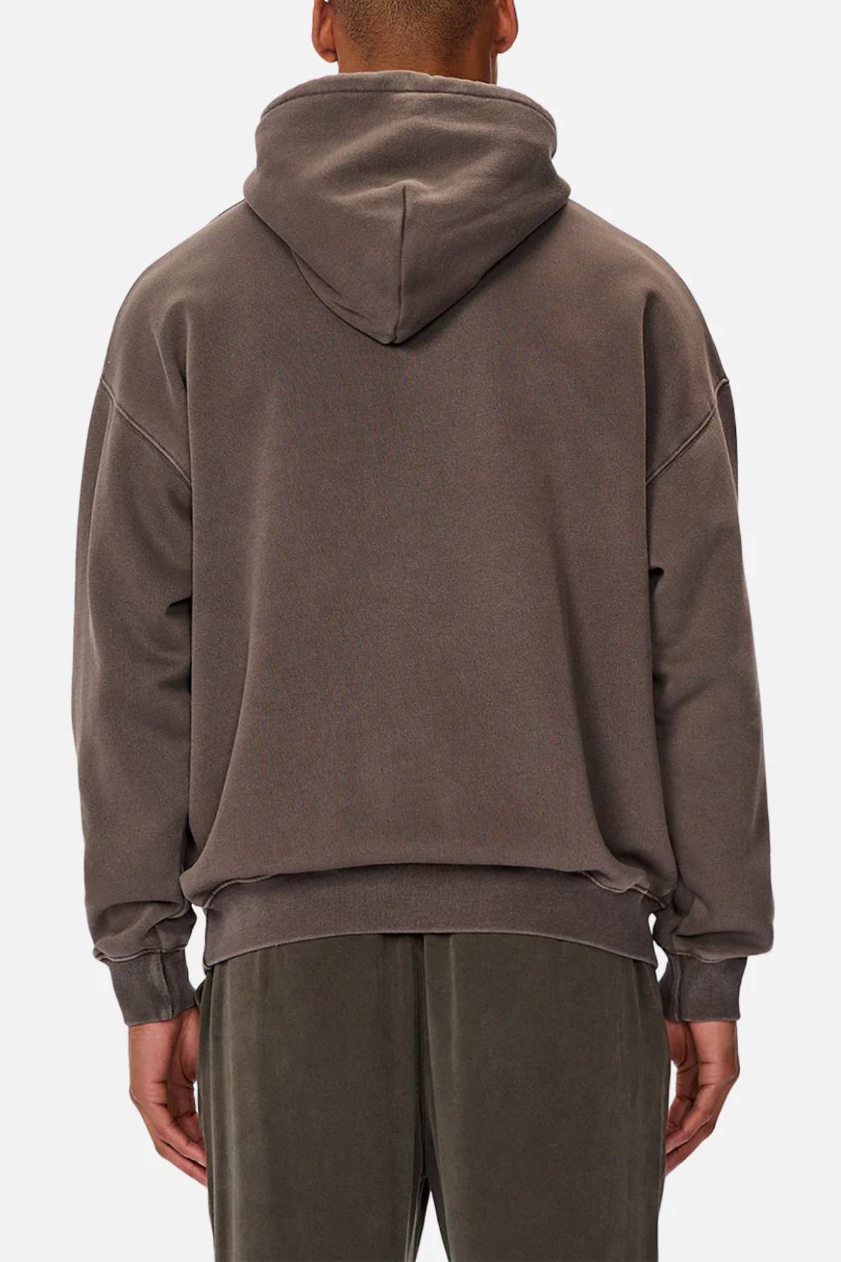 A person is seen from the back wearing an Industrie Del Sur Washed Hoodie and matching loose-fitting pants in dark gray acid wash. The hoodie has a large hood and long sleeves, creating a complete casual look against a plain white background.