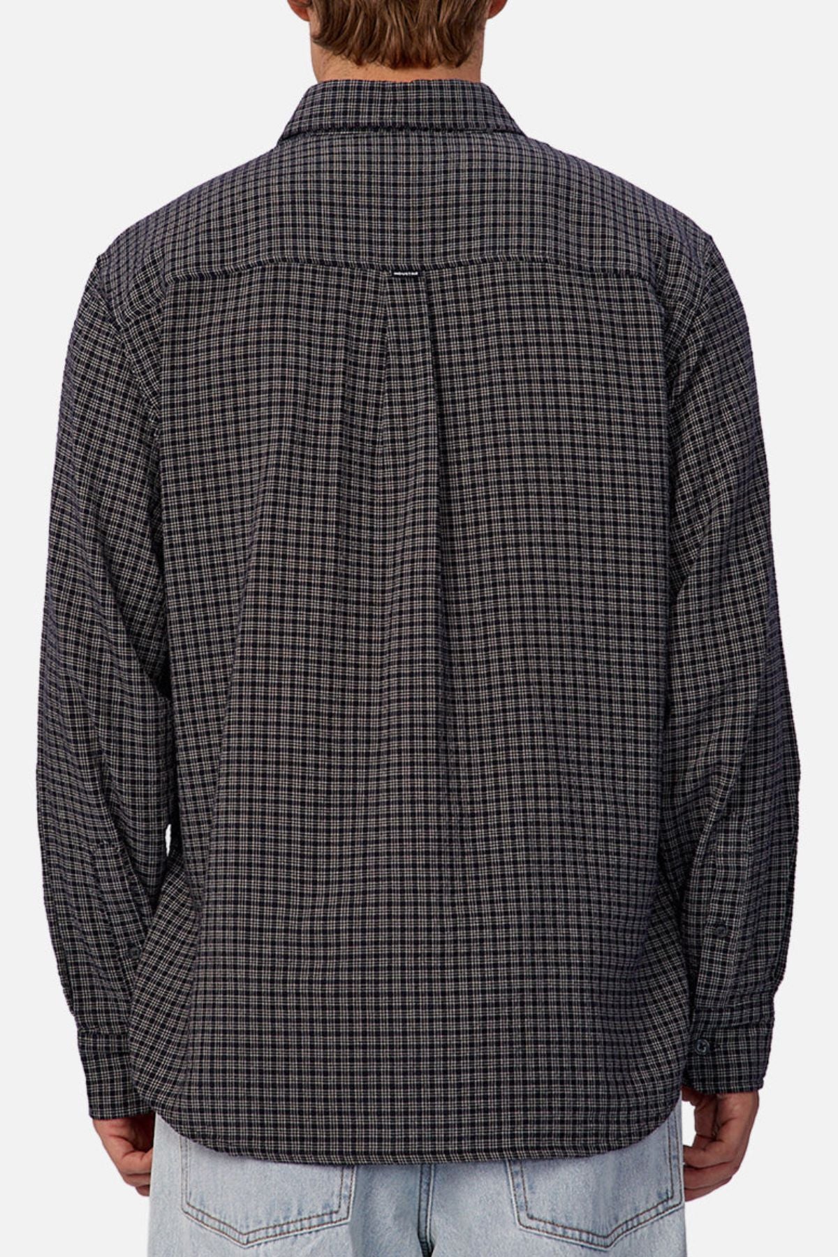A person is shown from the back wearing the Industrie The Diego Long Sleeve Shirt in a black and gray check pattern, paired with light blue jeans, against a plain background.