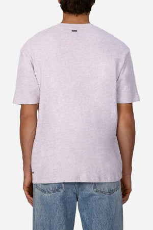 A person with dark hair, facing away, is showcasing an oversized look featuring a light gray Industrie The Henderson Boucle Tee made from 100% cotton, paired elegantly with blue jeans against a plain white background.