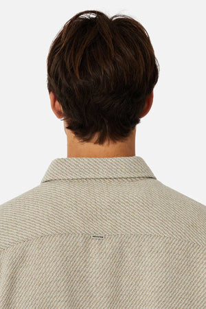 Rear view of a person with brown hair wearing a stylish Industrie The Jackson Shirt, featuring a light texture. Its relaxed fit prioritizes comfort, focusing on the upper back and collar against a white background.