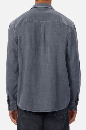 A person is shown from the back against a plain light background wearing the Industrie Lisbon Long Sleeve Shirt with dark jeans.