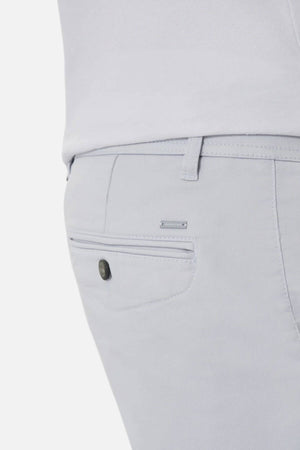Close-up of the back pocket on light grey Industrie The New Drifter Cuba Short, featuring a single buttoned pocket and a metallic brand tag above it. The modern slim fit pairs comfortably with a white top for stylish wear.