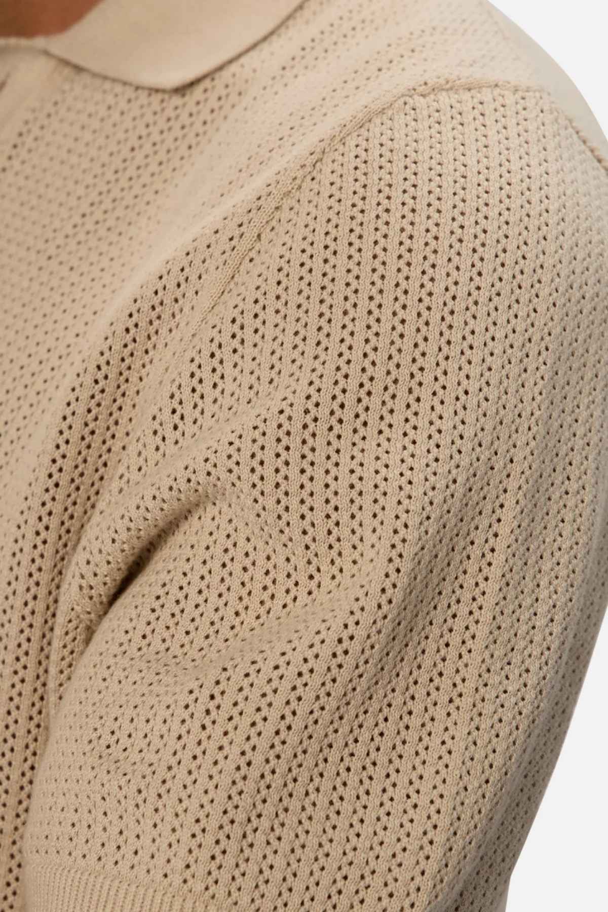 Close-up of a textured sleeve from the Industrie The Serrano Polo, highlighting the intricate zigzag pattern and detailed stitching.